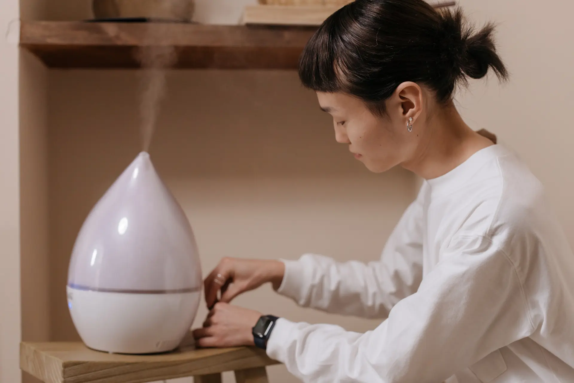 A woman using a humidifier at home