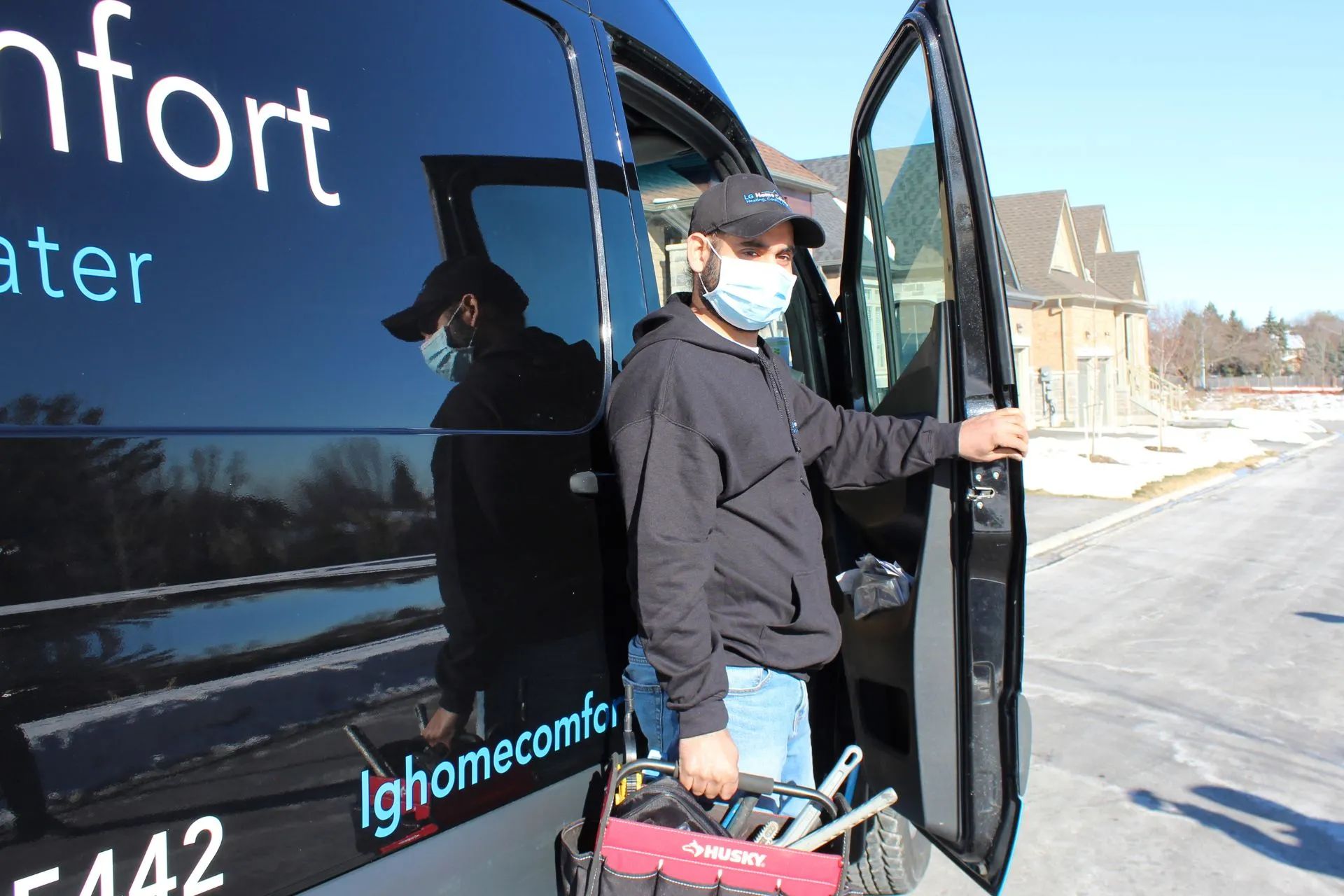 LG Home Comfort technicians walking out of a van
