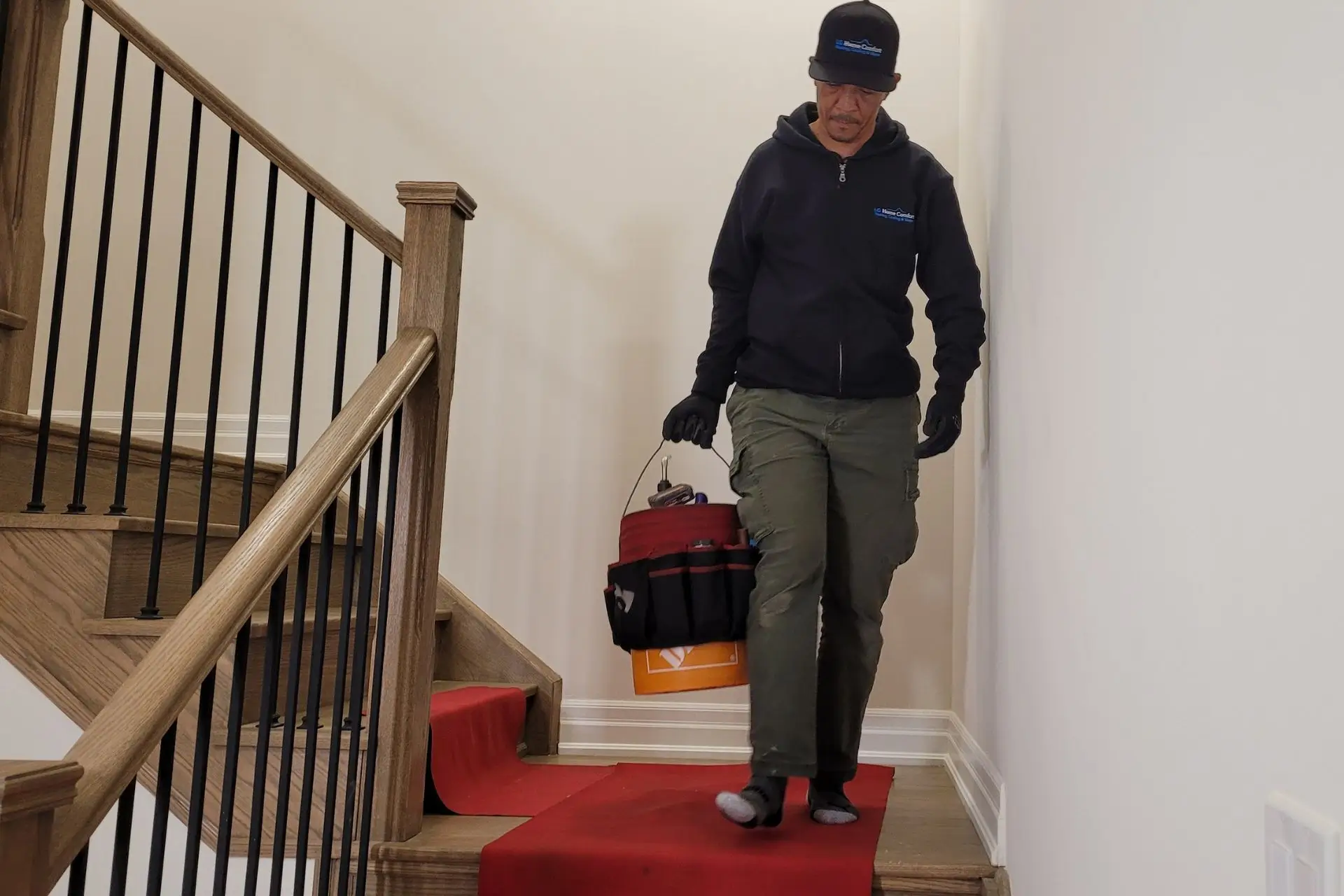 Technician walking down the stairs with tools